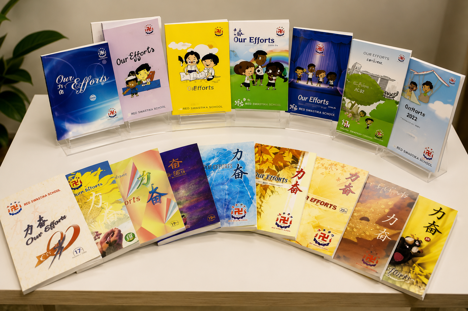Display of past editions of Our Efforts, Red Swastika School's yearly publication featuring students' writing, creative works and learning experiences, reflecting the growth of young authors across the years.